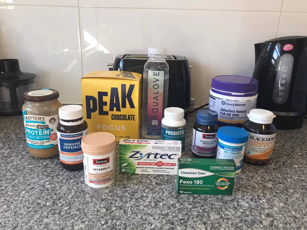 An image showing an assortment of vitamins, supplements, medicines and less conventional treatments such as focus chocolate and protein peanut butter. 